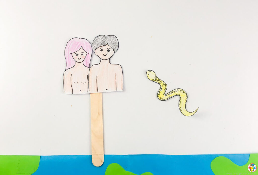 adam and eve printed template attached to a popsicle stick for adam and eve paper plate craft for kids